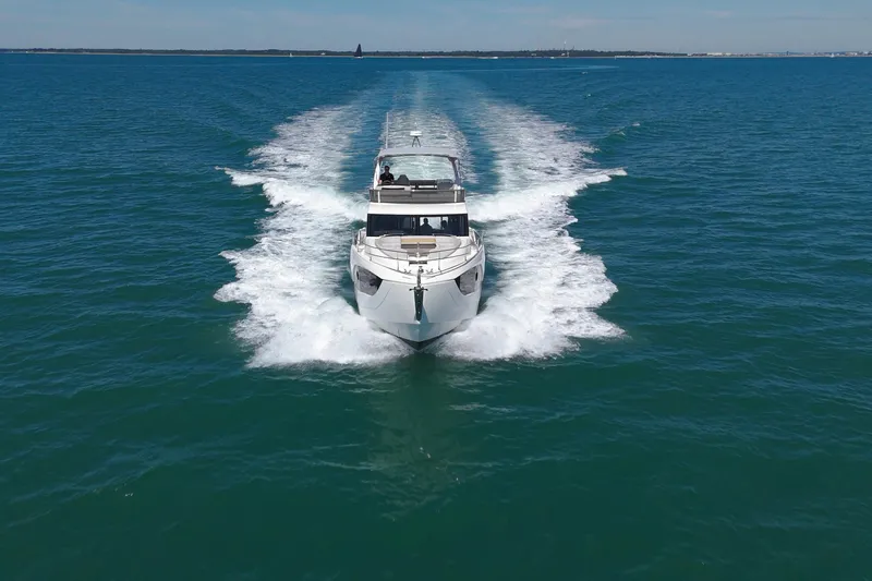 In Stock Yacht Photos Pics 2025 Absolute 47 Fly yacht cruising on open sea, creating a dynamic wake.