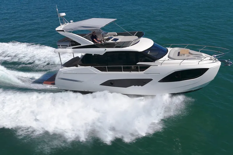 In Stock Yacht Photos Pics 2025 Absolute 47 Fly yacht cruising on open water, showcasing sleek design and luxury features.