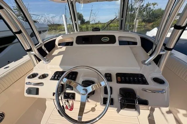  Yacht Photos Pics 2013 Grady-White Canyon 336 boat helm with steering wheel and control panel.