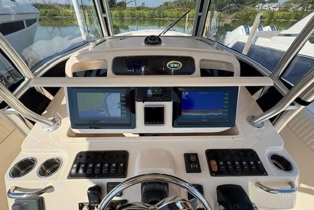 Yacht Photos Pics 2013 Grady-White Canyon 336 helm with dual navigation screens and control panel.