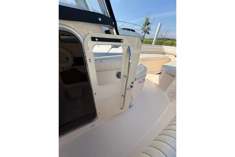  Yacht Photos Pics 2013 Grady-White Canyon 336 boat interior with seating and open cabin door.