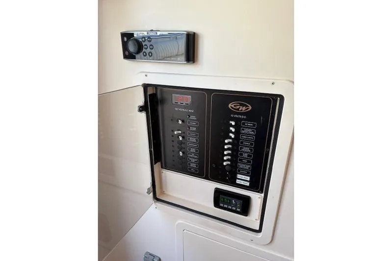  Yacht Photos Pics Control panel of 2013 Grady-White Canyon 336 boat, featuring switches and a stereo system.