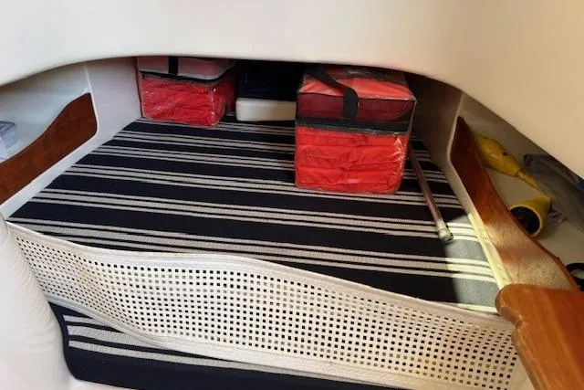  Yacht Photos Pics 2013 Grady-White Canyon 336 cabin interior with striped cushions and storage bags.