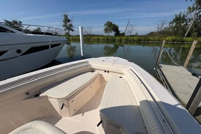 Yacht Photos Pics 2013 Grady-White Canyon 336 boat docked by a serene lake.