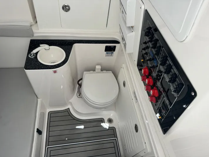  Yacht Photos Pics 2022 Sea Fox 328 Commander boat interior with toilet, sink, and control panel.