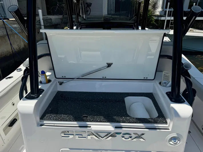  Yacht Photos Pics 2022 Sea Fox 328 Commander boat with open storage compartment and visible branding.