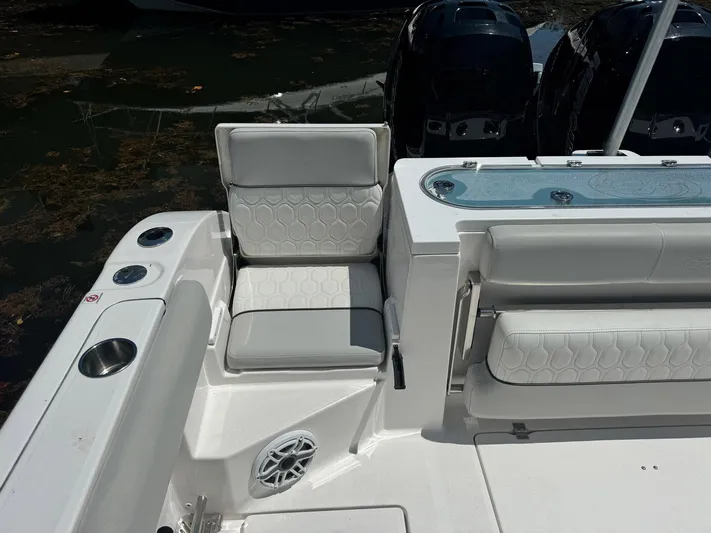  Yacht Photos Pics 2022 Sea Fox 328 Commander boat interior with cushioned seating and dual outboard motors.
