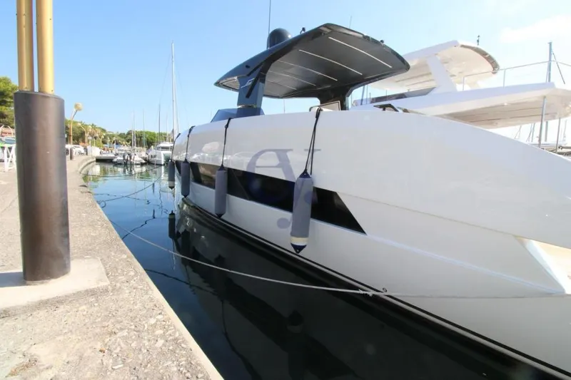 L Yacht Photos Pics 2023 MandaYachts Manda S05 docked at marina, sleek modern design.