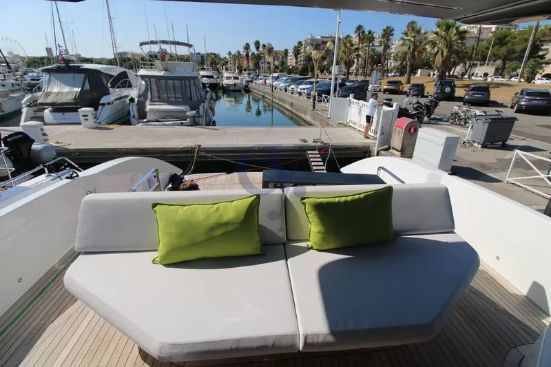 L Yacht Photos Pics Luxury MandaYachts Manda S05, 2023 model, docked with plush seating and vibrant green cushions.