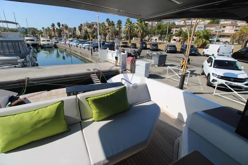 L Yacht Photos Pics Luxurious 2023 MandaYachts Manda S05 docked, featuring elegant seating with green cushions.