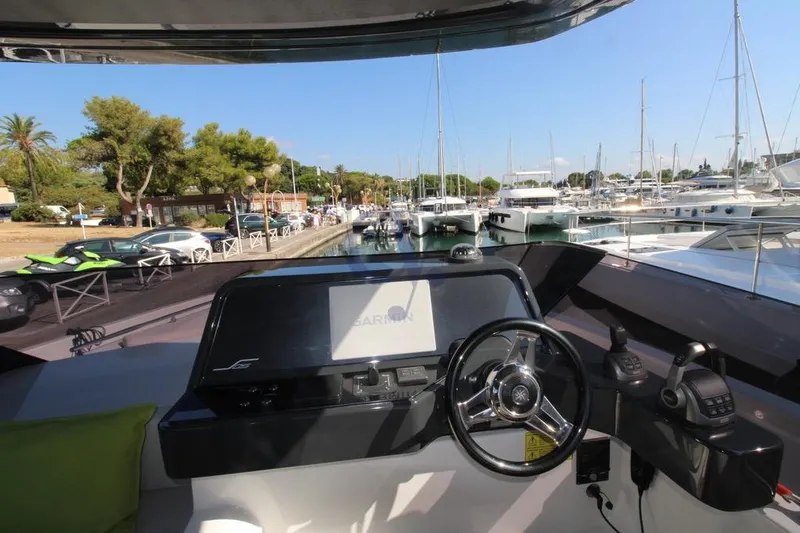 L Yacht Photos Pics Cockpit view of 2023 MandaYachts Manda S05, docked in a marina with clear skies.