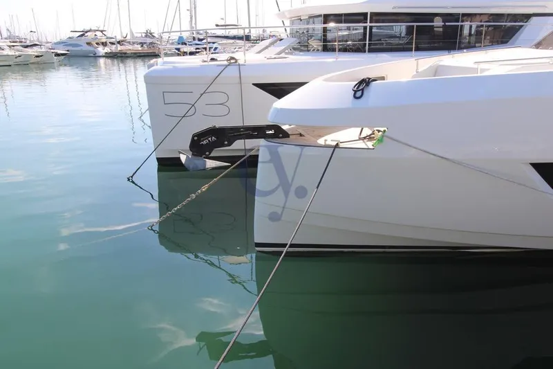 L Yacht Photos Pics Modern MandaYachts Manda S05, 2023 model, docked at a marina with clear reflections.