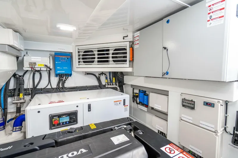  Yacht Photos Pics Engine room of 2025 Pearl 63 yacht with control panels and equipment.