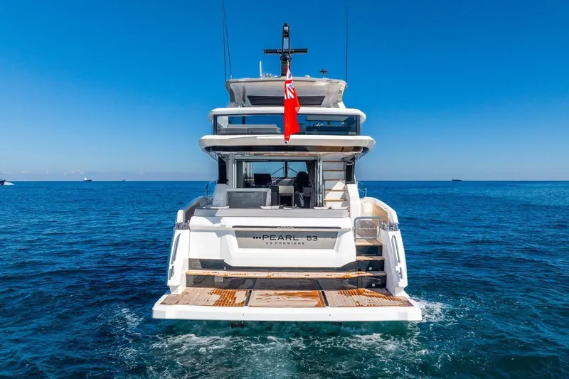  Yacht Photos Pics Luxury Pearl 63 yacht, 2025 model, cruising on open sea under clear blue sky.
