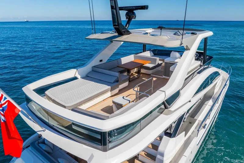  Yacht Photos Pics Luxurious 2025 Pearl 63 yacht with spacious deck and modern design on open sea.