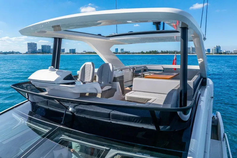  Yacht Photos Pics Luxurious 2025 Pearl 63 yacht with spacious deck, cruising on clear blue waters.