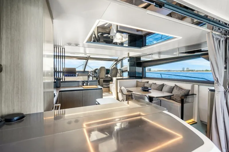  Yacht Photos Pics Luxurious interior of 2025 Pearl 63 yacht with modern dining and navigation area.