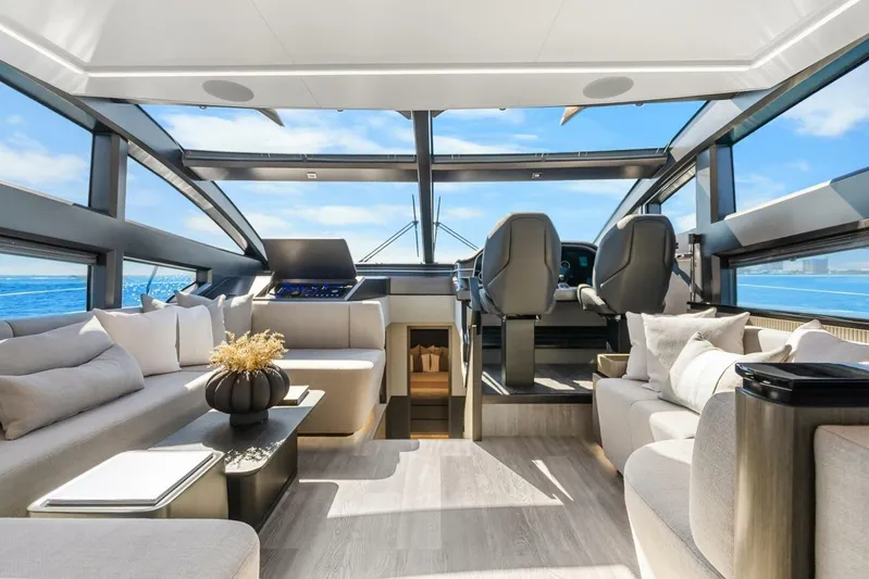  Yacht Photos Pics Luxurious interior of 2025 Pearl 63 yacht with modern seating and panoramic ocean views.