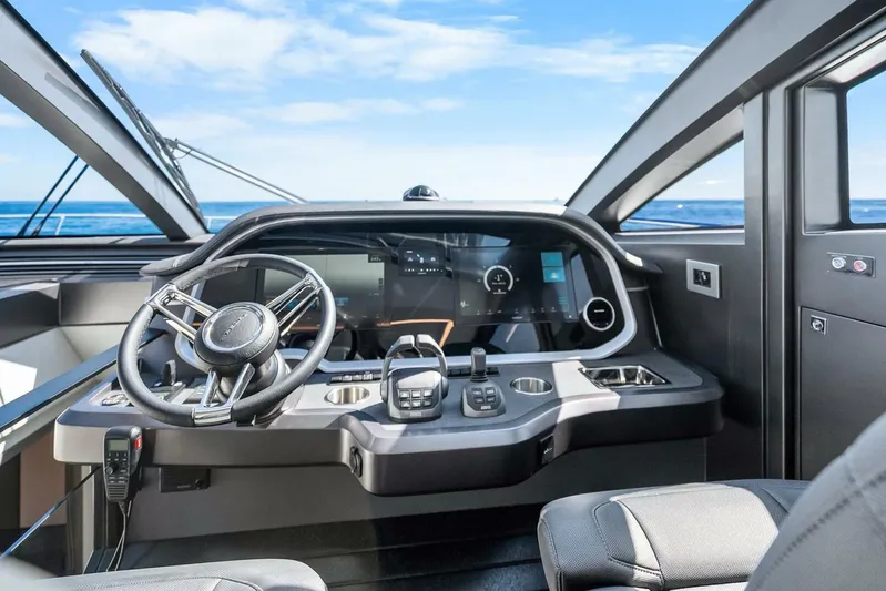  Yacht Photos Pics Modern helm of 2025 Pearl 63 yacht with sleek design and advanced controls.