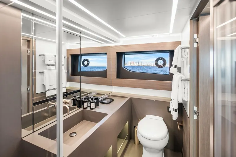  Yacht Photos Pics Luxurious bathroom interior of 2025 Pearl 63 yacht with ocean view window.