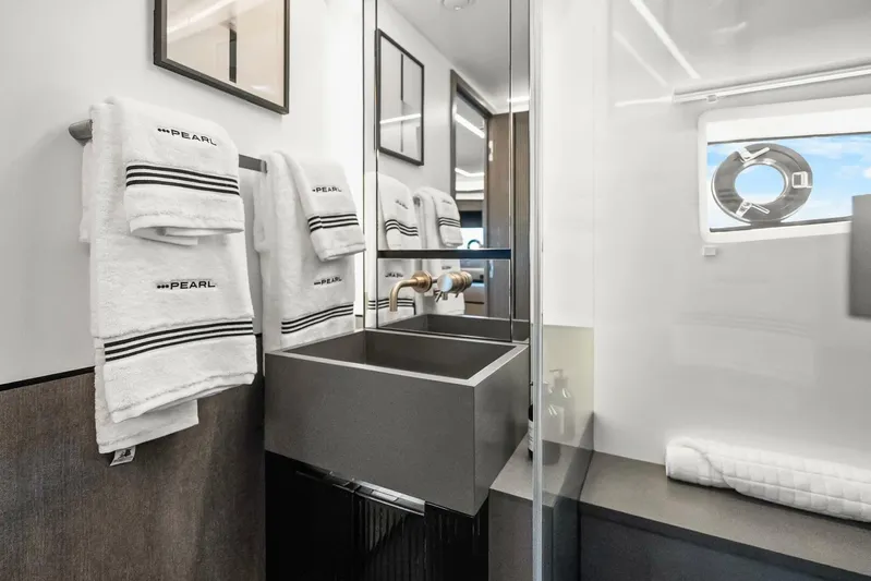  Yacht Photos Pics Luxurious bathroom in 2025 Pearl 63 yacht with modern sink and branded towels.