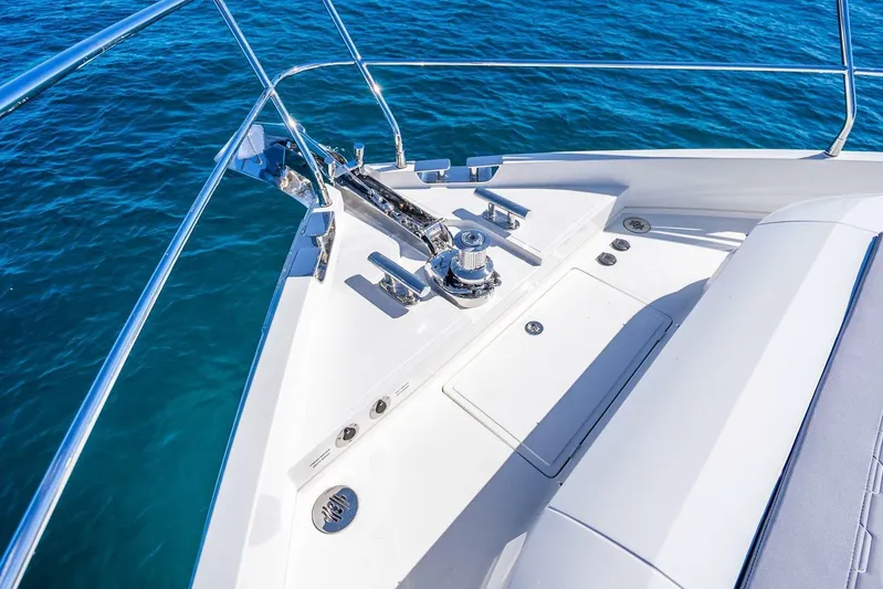  Yacht Photos Pics Bow of 2025 Pearl 63 yacht with anchor system, on clear blue water.