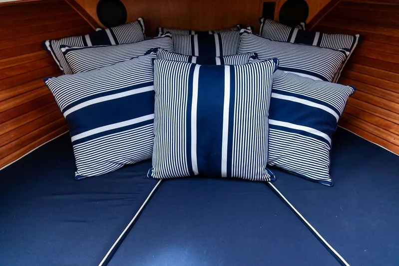 Golightly Yacht Photos Pics 2023 Hinckley Picnic Boat 34 S interior with striped cushions, showcasing elegant nautical design.
