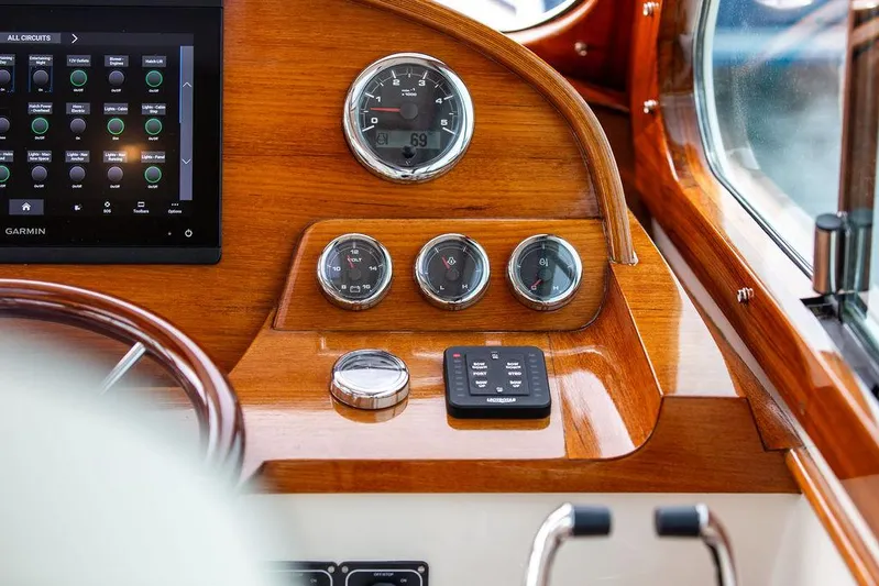 Golightly Yacht Photos Pics 2023 Hinckley Picnic Boat 34 S dashboard with gauges and controls, featuring wood finish.