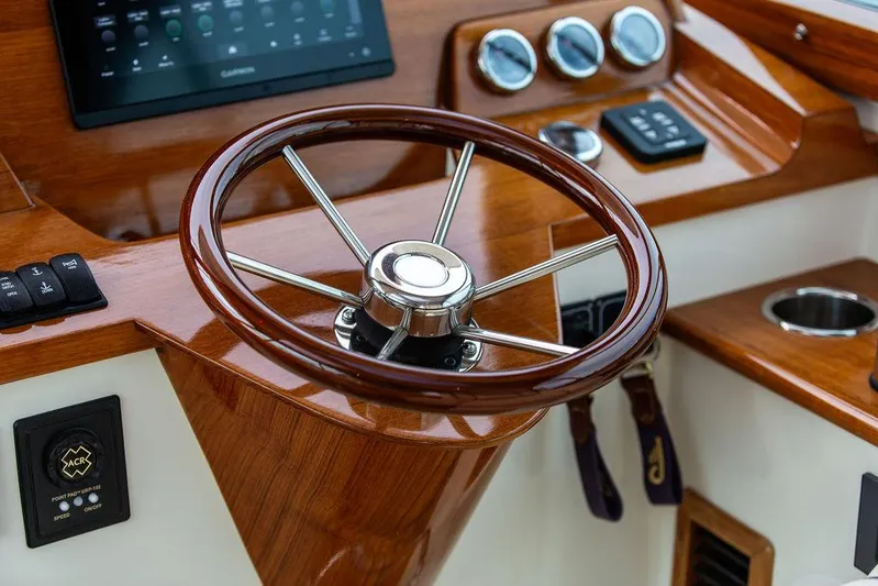 Golightly Yacht Photos Pics 2023 Hinckley Picnic Boat 34 S helm with wooden steering wheel and modern controls.