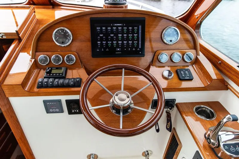 Golightly Yacht Photos Pics 2023 Hinckley Picnic Boat 34 S helm with wooden steering wheel and modern controls.