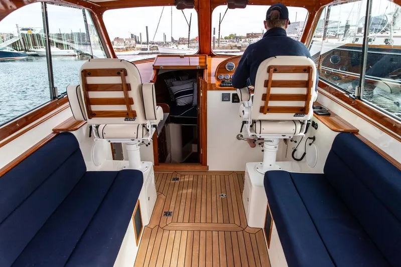 Golightly Yacht Photos Pics 2023 Hinckley Picnic Boat 34 S interior with wooden flooring and blue seating.