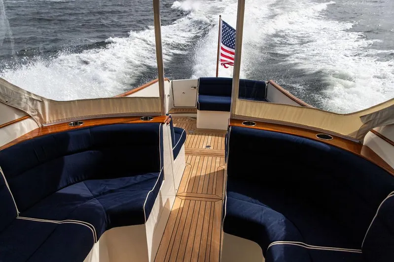 Golightly Yacht Photos Pics 2023 Hinckley Picnic Boat 34 S cruising with elegant seating and American flag.