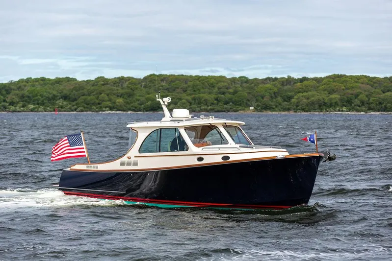Golightly Yacht Photos Pics 2023 Hinckley Picnic Boat 34 S cruising on a lake with American flag.