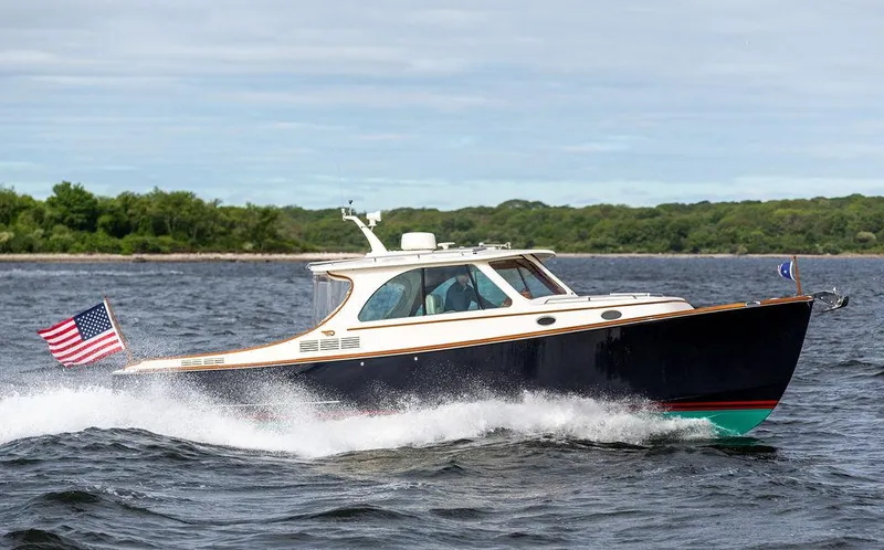Golightly Yacht Photos Pics 2023 Hinckley Picnic Boat 34 S cruising on open water with American flag.