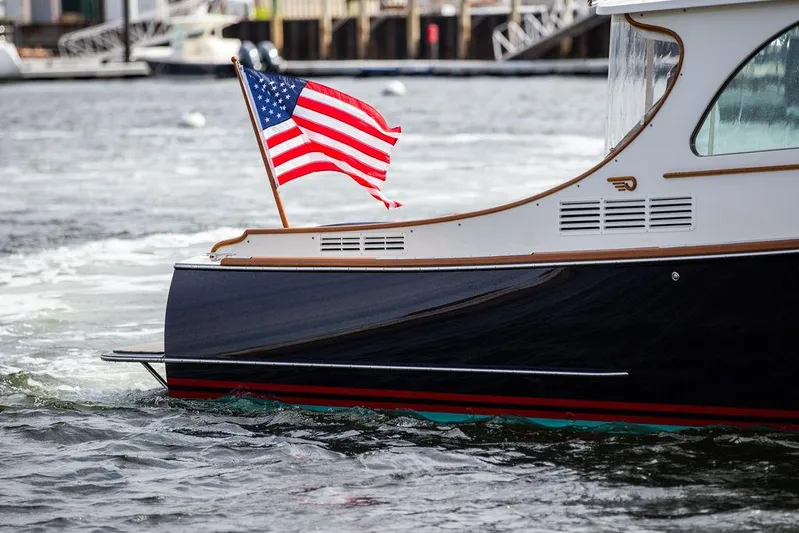 Golightly Yacht Photos Pics 2023 Hinckley Picnic Boat 34 S with American flag on water.