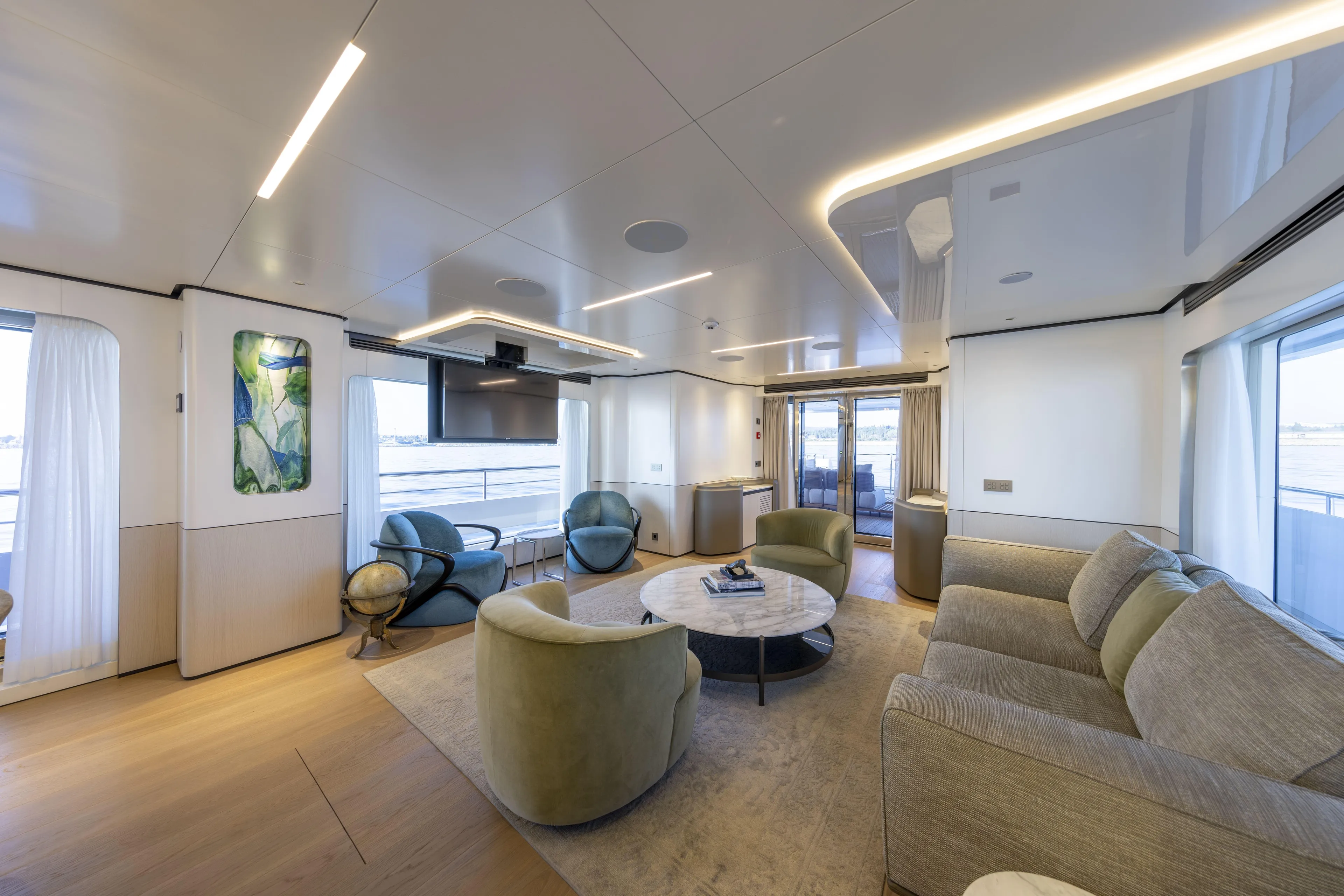 Luxurious interior of 2025 Bee BEE Explorer Yacht with modern furnishings and large windows.
