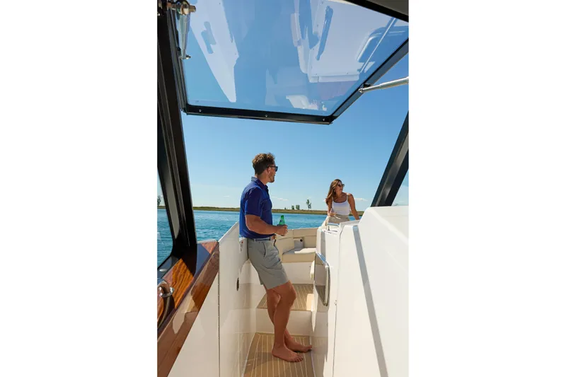 In Stock Yacht Photos Pics Two people enjoying a sunny day on a 2026 MJM 47X boat.