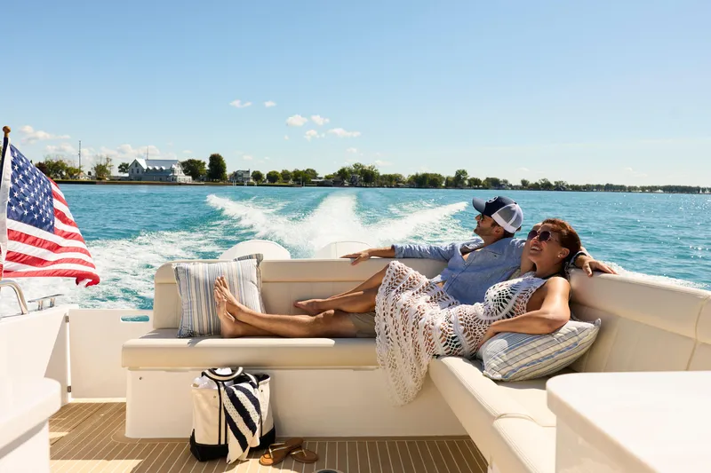 In Stock Yacht Photos Pics Couple relaxing on MJM 47X boat, 2026 model, cruising on a sunny day.