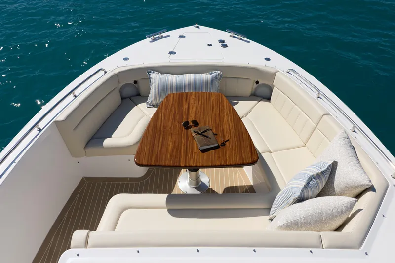 In Stock Yacht Photos Pics Luxurious seating area on 2026 MJM 47X yacht with elegant cushions and wooden table.