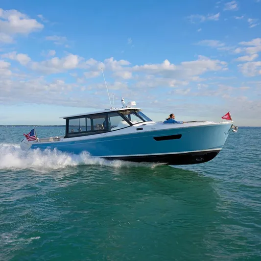 In Stock Yacht Photos Pics 2026 MJM 47X yacht cruising on open water under a clear blue sky.