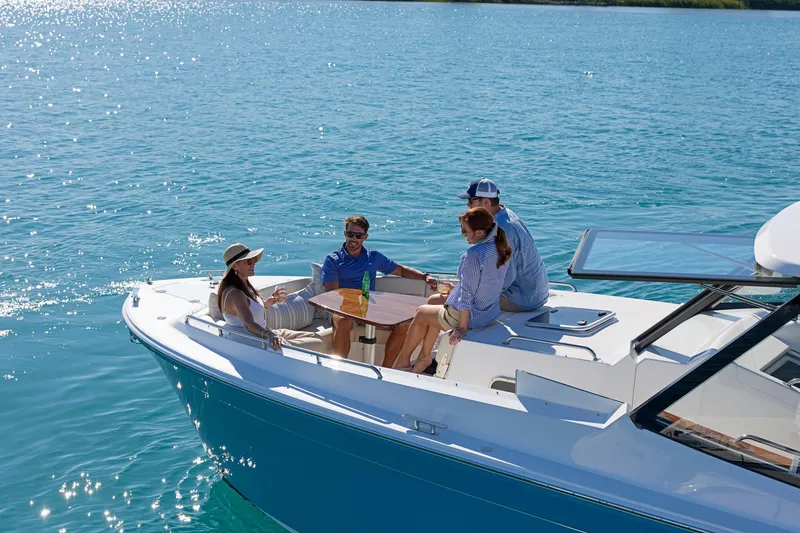 In Stock Yacht Photos Pics Four people relaxing on a 2026 MJM 47X yacht in sunny waters.