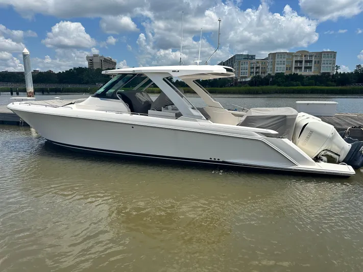 Praiano Yacht Photos Pics 2019 Tiara Sport 38 LS boat docked on a sunny day with buildings in the background.