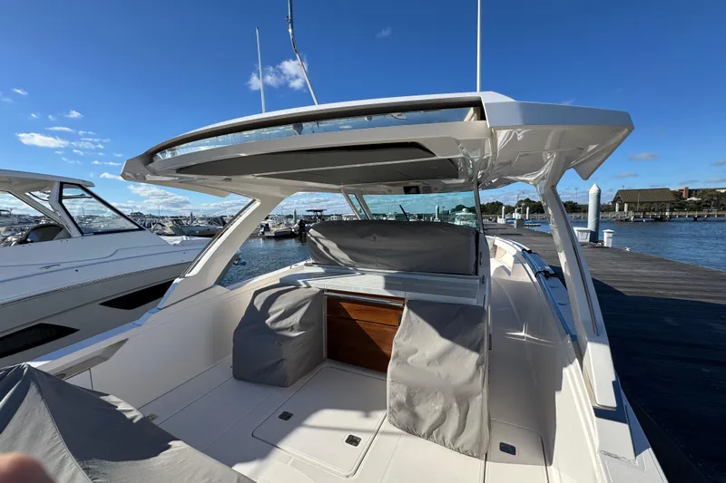 Praiano Yacht Photos Pics 2019 Tiara Sport 38 LS boat docked, featuring sleek design and spacious seating area.