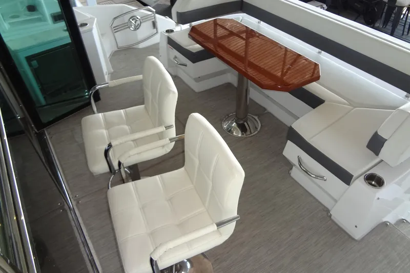 Imagine Yacht Photos Pics 2021 Cruisers Yachts 50 Cantius interior with white seating and wooden table.