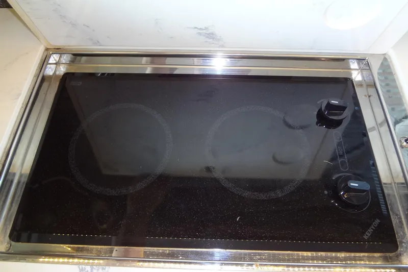 Imagine Yacht Photos Pics Stovetop in 2021 Cruisers Yachts 50 Cantius, featuring sleek black glass surface.