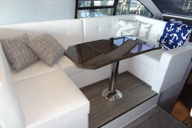 Imagine Yacht Photos Pics Luxurious interior of 2021 Cruisers Yachts 50 Cantius with elegant seating and modern table design.