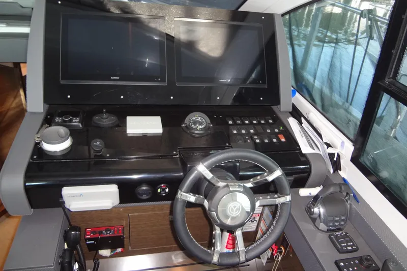 Imagine Yacht Photos Pics Helm of 2021 Cruisers Yachts 50 Cantius with dual screens and modern controls.