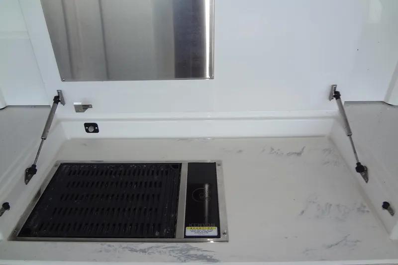 Imagine Yacht Photos Pics Outdoor grill area on 2021 Cruisers Yachts 50 Cantius, featuring stainless steel and marble surfaces.