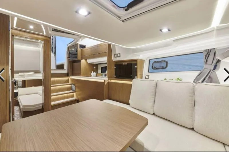  Yacht Photos Pics Luxurious interior of 2021 Jeanneau Leader 12.5 WA yacht with modern furnishings and ambient lighting.