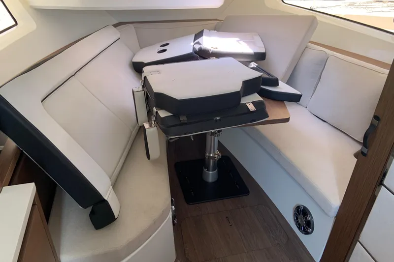  Yacht Photos Pics 2021 Jeanneau Leader 12.5 WA cabin interior with convertible seating and table.